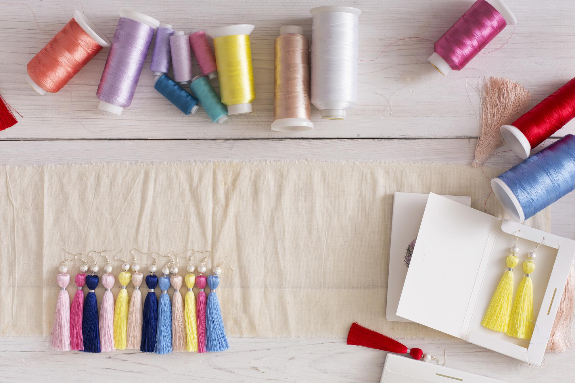 Workshop table with threads and embroidered samples
