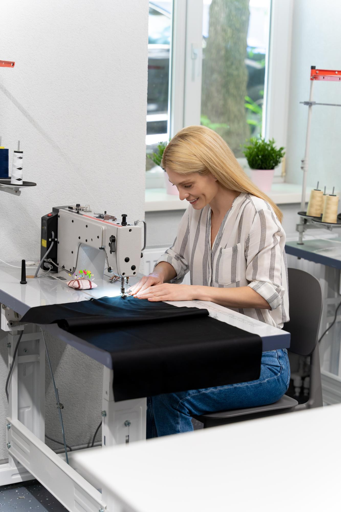 Studio workspace with embroidery machine and samples